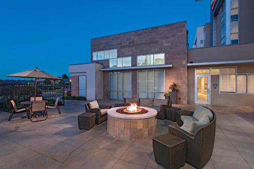 a patio with a fire pit in front of a building at Residence Inn by Marriott Jackson The District at Eastover in Jackson