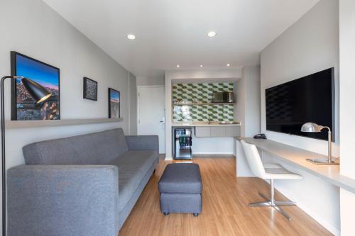 a living room with a couch and a table at Mercure Sao Paulo Moema in Sao Paulo