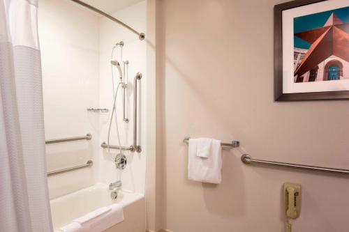 a bathroom with a shower and a sink and a toilet at Courtyard by Marriott San Antonio North Stone Oak At Legacy in San Antonio