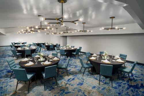 a conference room with tables and chairs and a chandelier at Four Points by Sheraton Destin - Fort Walton Beach in Fort Walton Beach