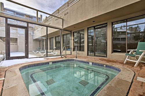 a swimming pool in the middle of a house at Walk to Dtwn Winter Park Studio with Hot Tub Access in Winter Park