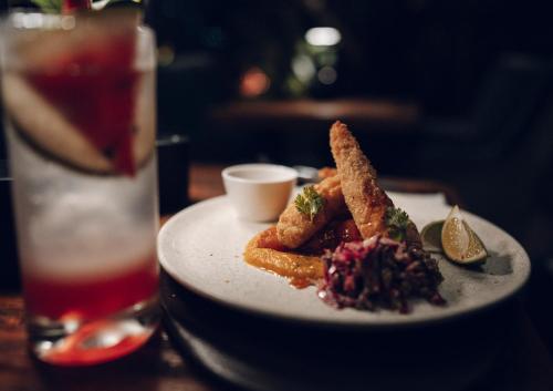 a plate of food on a table with a drink at Bosko in Guatapé