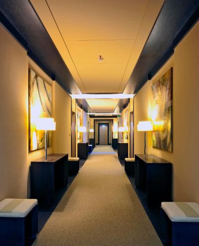 a hallway in a hotel with tables and lamps at Villa Maria Hotel & SPA in Francavilla al Mare