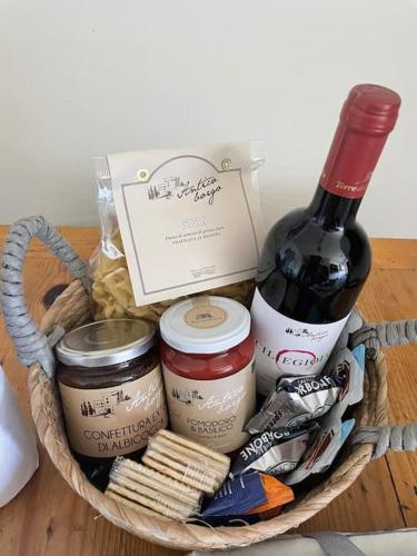 a basket filled with food and a bottle of wine at Casale de L'Ovo Tuscany Relax in Gabbro