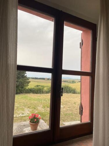 a window with a view of a field outside at Casale de L'Ovo Tuscany Relax in Gabbro