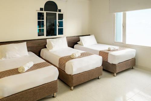 Ένα ή περισσότερα κρεβάτια σε δωμάτιο στο Hotel Americas San Andres Islas Colombia