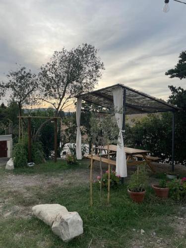a picnic area with a canopy and a picnic table at Casale de L'Ovo Tuscany Relax in Gabbro