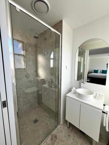 a bathroom with a shower and a sink at Pipers Lodge in Perisher Valley