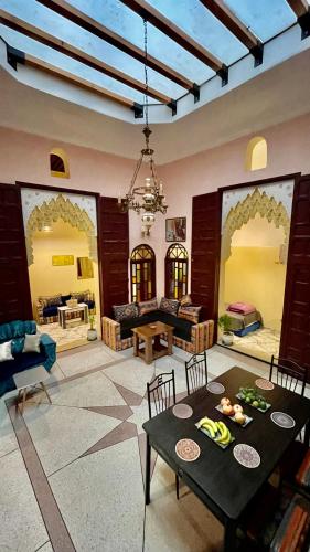 a large living room with a table and chairs at Riad Dar Al Manzah in Rabat
