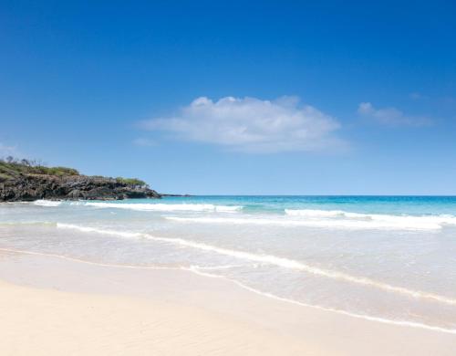 a sandy beach with the ocean in the background at ❤PiH❤ Ocean Palms Villa Stunning Ocean View Mauna Kea Resort in Hapuna Beach