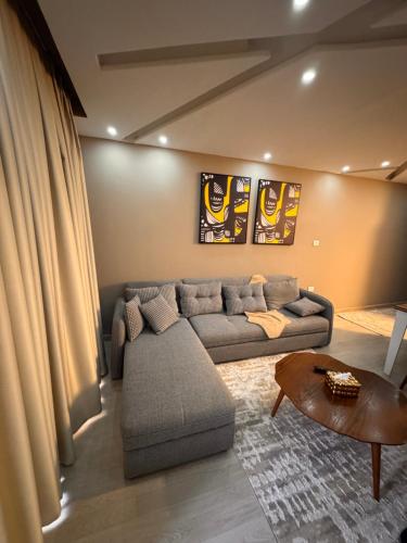 a living room with a couch and a table at Luxury - 2 Bedroom Apartment B7 in Madinaty