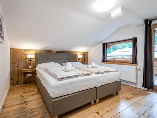 a bedroom with a large bed and a window at Alte Mühle in Hopfgarten im Brixental