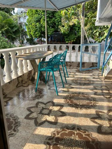 a table and a chair on a balcony at Alojamiento Doradal Antioquía, en el santorini colombiano, la aldea in Doradal