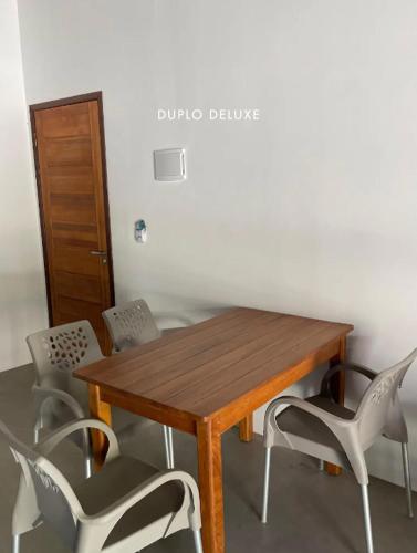 a wooden table and chairs in a room at Casas de Juan in Morro de São Paulo