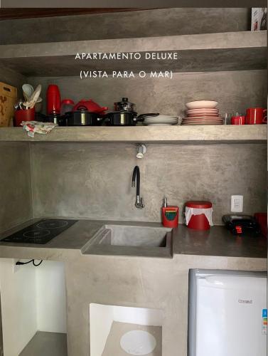 a kitchen counter with a sink and a stove at Casas de Juan in Morro de São Paulo