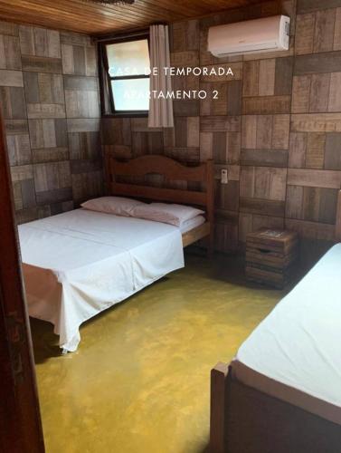 a room with a flooded floor with two beds and a window at Casas de Juan in Morro de São Paulo