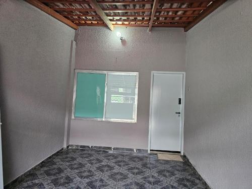an empty room with a window and a door at CIG Hostel in Goiânia