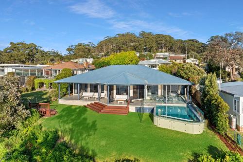 an aerial view of a house with a swimming pool at Bellevue at Hyams, Hyams Beach in Hyams Beach