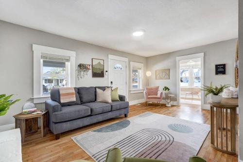 a living room with a couch and a table at Institute Aura! Family Home w Quiet Workspace in Colorado Springs