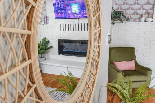 a mirror in a living room with a fireplace at Institute Aura! Family Home w Quiet Workspace in Colorado Springs