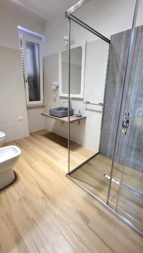a bathroom with a shower and a sink at Villa Andres in Sassari