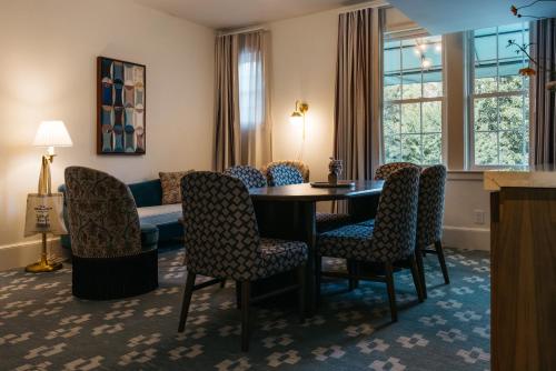 a living room with a table and chairs and a couch at Hotel Granada, a Design Hotel in Atlanta