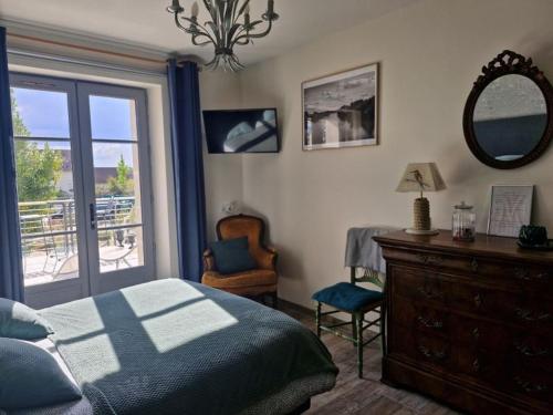 a bedroom with a bed and a dresser and a mirror at Chambre PMR tout confort avec terrasse en bord de canal, animaux acceptés, proche centre-ville de Briare - FR-1-590-368 in Briare