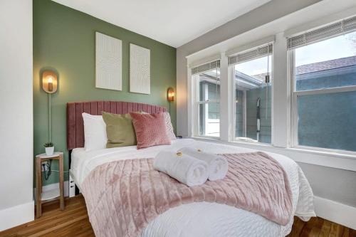 a bedroom with a large bed with towels on it at Institute Aura! Family Home w Quiet Workspace in Colorado Springs