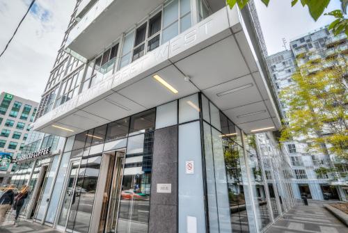 a building with glass doors in a city at Rivetstays - The Atmos I in Toronto