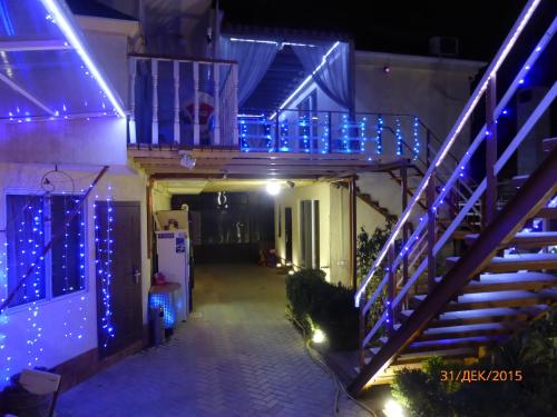 a house with blue lights on the stairs at ApartHotel Dom in Odesa