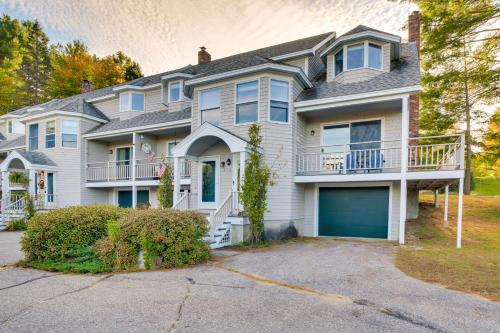 a large white house with a garage at 6 Mi to Sunday River Condo Near Bethel Village! in Bethel