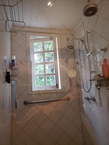 a bathroom with a shower and a window at Flor da Serra in Brumadinho
