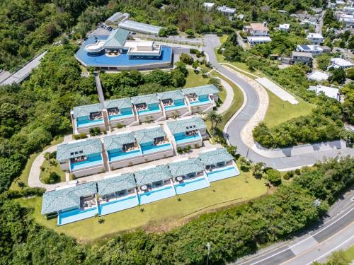 an aerial view of a building with swimming pools at Oriental Hills Okinawa in Onna