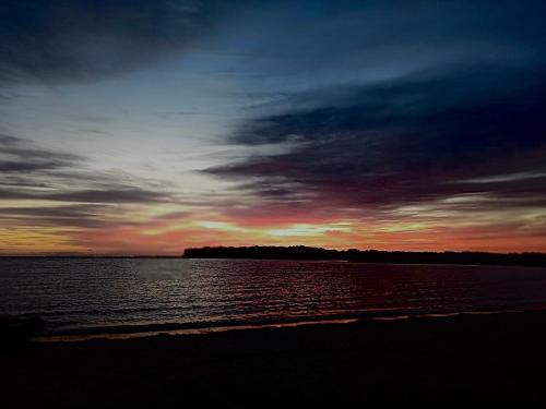 a sunset over a large body of water at Arambe cabañas "Tupá y Arasy in Ituzaingó