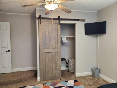 a room with a wooden door and a ceiling fan at Tranquil Mesa Retreat in Mesa