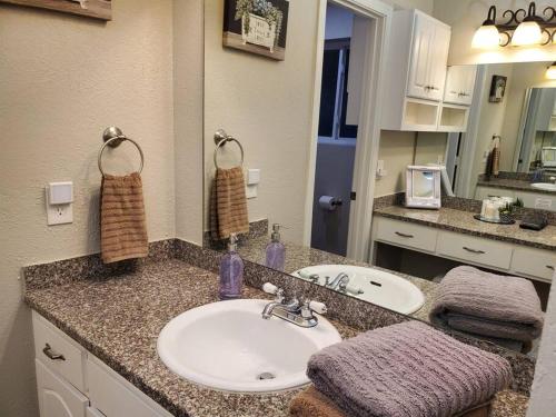 a bathroom with a sink and a mirror at Tranquil Mesa Retreat in Mesa