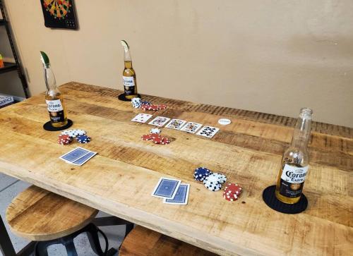 a wooden table with three bottles of beer on it at Tranquil Mesa Retreat in Mesa
