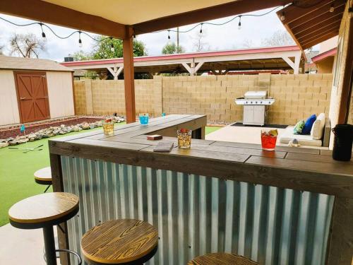 a bar in a backyard with two stools at Tranquil Mesa Retreat in Mesa
