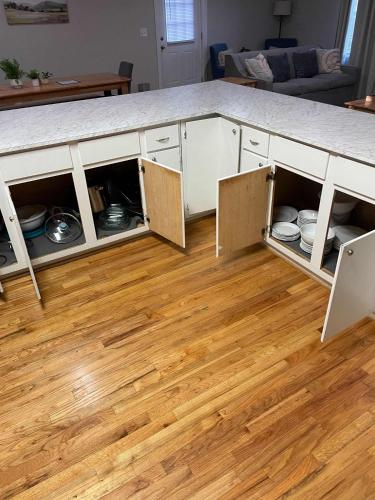 a kitchen island with open cabinets with plates and dishes at Mins to USC Hospital Zoo Columbia Duet-Unit B in West Columbia
