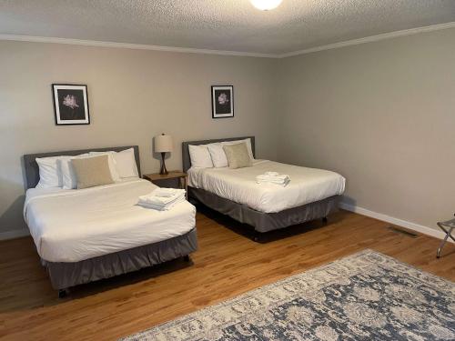 two beds in a room with wooden floors at Mins to USC Hospital Zoo Columbia Duet-Unit A in West Columbia