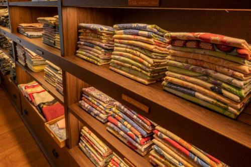 a shelf filled with lots of folded blankets at Shionoyu Onsen Rengetsu in Nasushiobara