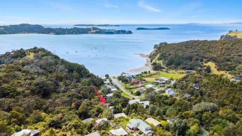 an aerial view of the shoreline of a beach at Opahi TreeHouse - Mahurangi West Holiday Home in Warkworth