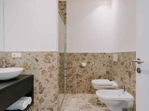 a bathroom with a sink and a toilet and a shower at The Hills Merano in Merano