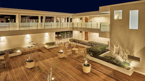 a large building with potted plants on a wooden floor at Tokyu Vacations Izukougen in Ito