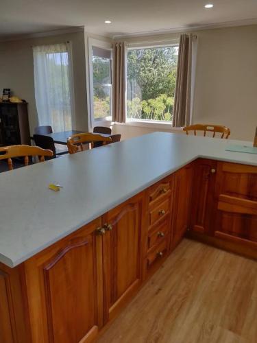 an empty kitchen with a large white counter top at Farm Stay On The Valley in Newfield