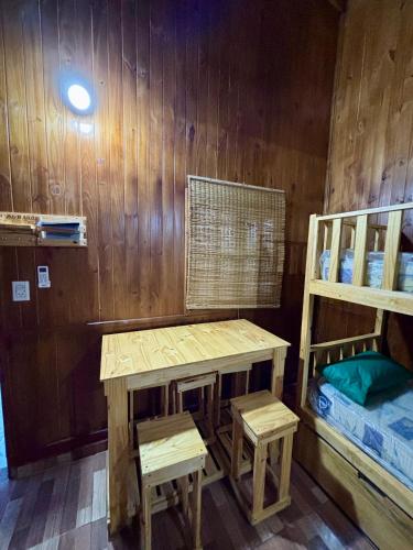 a room with a table and a bunk bed at Arambe cabañas "Tupá y Arasy in Ituzaingó