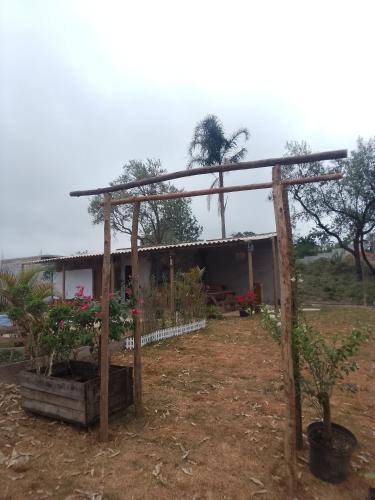eine hölzerne Pergola vor einem Haus in der Unterkunft Chalé chacara dos eucaliptos in Itapecerica da Serra