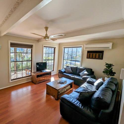 a living room with a couch and a coffee table at Cupie's Cabin in Talbingo