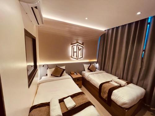 a small room with two beds and a window at Ho-Motel International in Kathmandu