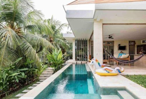 a house with a swimming pool with an inflatable poolvisor at Exquisite luxury Villa Candidasa in Candidasa